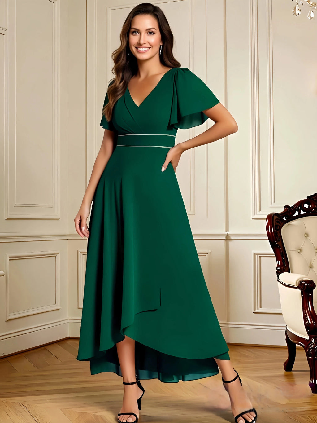 high low mother of the bride dress with V-neck, flutter sleeves, and flowing chiffon skirt shown in a formal wedding guest setting